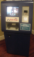 The QuikTrak machine is blue. It has a touch-sensitive screen, a credit card slot, and a hopper for tickets.