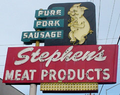 Stephen’s Meat Products has a large neon sign with a dancing pig and the caption, "Pure Pork Sausage".