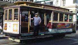 Cable cars are small, wooden vehicles that run on "tracks" in the street. Passengers can hang from the sides.