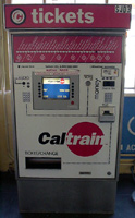 The Caltrain ticket machine is a large red and white console. It says "tickets" and "Caltrain".