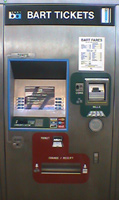 The BART ticket machine is a large metallic console. It says "BART Tickets".